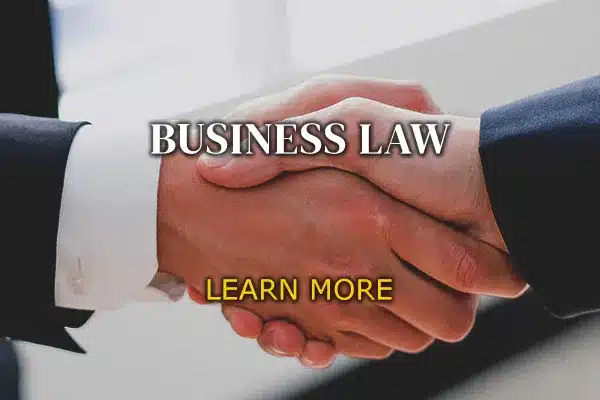 Two men shaking hands and words titled "Business Law".